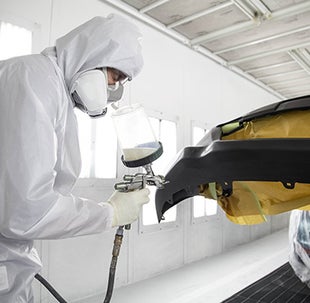Collision Center Technician Painting a Vehicle | Phillips Toyota in Leesburg FL